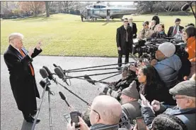  ?? WIN MCNAMEE/GETTY ?? President Trump speaks to the news media while departing the White House on Thursday.
