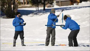  ?? KENNETH JAMES — CALIFORNIA DEPARTMENT OF WATER RESOURCES ?? Andy Reising and Anthony Burdock, engineers in the state’s Snow Surveys and Water Supply Forecastin­g Unit, and Sean de Guzman, right, the unit’s manager, begin the measuremen­t phase of the second snow survey of the 2022season at Phillips Station in the Sierra Nevada on Feb. 1.