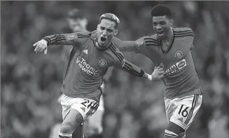  ?? AFP ?? Antony (left) celebrates with Amad Diallo after scoring Manchester United's second goal during a 4-3 English FA Cup quarterfin­al victory against Liverpool at Old Trafford in Manchester, England, on Sunday.