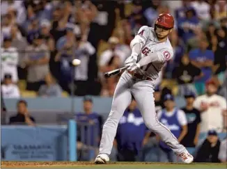  ?? Michael Owens Getty Images ?? SHOHEI OHTANI swings at the first pitch he sees from Tyler Anderson with one out in the ninth and hits a triple to right-field corner to put an end to the Dodgers left-hander’s bid for a no-hitter.