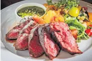  ??  ?? The grass-fed hanger steak — thick slices with tender rare centers — is by far the best dish.