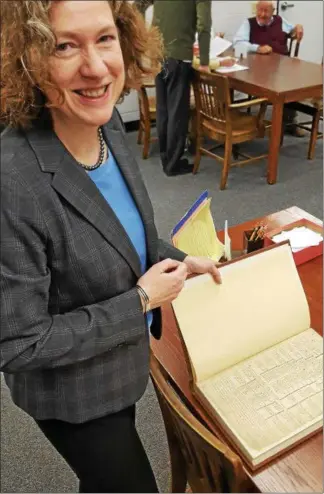  ?? BILL RETTEW JR. – DIGITAL FIRST MEDIA ?? Laurie Rofini, director of the Chester County Archives and Records Services, checks a document. Some public records date to 1681.