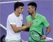  ?? MATTHEW STOCKMAN - GETTY IMAGES ?? Luca Nardi, left, is congratula­ted by Novak Djokovic after the young Italian upset the world’s No. 1 player.