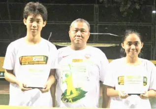  ?? PHOTOGRAPH COURTESY OF PPS ?? STEPHEN Fuertes (left) and Dhea Cua (right) celebrate after winning the Gov. Edwin Jubahib Cup national tennis championsh­ips. Also shown is Davao del Norte’s Provincial Agrarian Reform program officer II Tommy Bernaldez.