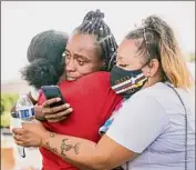  ?? Brandon Bell / Getty Images ?? People embrace after the hearing sentence of ex-minneapoli­s police officer Derek Chauvin.