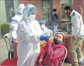  ??  ?? Health workers conduct Covid-19 testing in Noida on Wednesday.