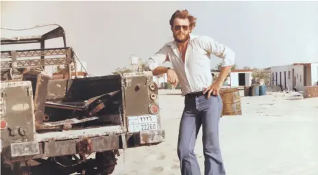  ?? Photos David Pryce ?? Clockwise from top, David Pryce at the camp in Ghayathi where he arrived in 1977; Mr Pryce tends to some newly planted ghaf trees in 1978. At Al Dhafra camp in 2018, where little remains of the ambitious project