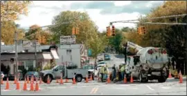  ??  ?? BELOW: City workers are shown tending to the water main break. For more,