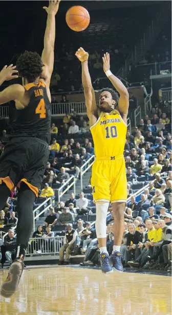  ?? — THE ASSOCIATED PRESS FILES ?? Derrick Walton Jr. and the Wolverines have ramped up the three-point shots this season.