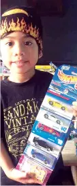  ??  ?? Faiz and some of his Hot Wheels race cars.