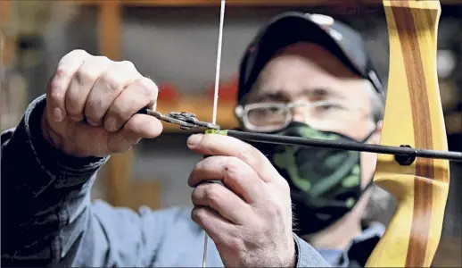  ?? Photos by Will Waldron / Times Union ?? Mick Mcguinness, owner of Brown’s Archery Shop, said he has seen a jump in business reflecting the increased demand for state hunting licenses. A Rockefelle­r Institute study shows that license payments have nearly tripled this year.