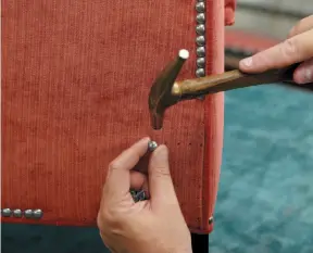  ?? ETHAN ALLEN HANDOUT PHOTO ?? A custom nailhead trim is applied to Ethan Allen’s Grace Chair, which is tailored by hand as shown here in their North American workshops.