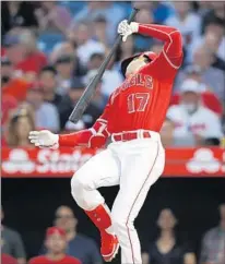  ?? Jae C. Hong Associated Press ?? SHOHEI OHTANI loses his balance after a swing in the fourth inning. Ohtani went 0 for 4 with three strikeouts.