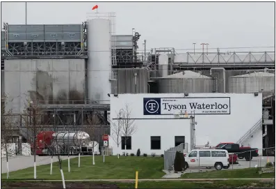  ?? (AP) ?? Vehicles sit outside the Tyson Foods plant in Waterloo, Iowa, in May. A recently amended wrongful-death lawsuit claims that the plant’s manager “organized” a betting pool for supervisor­s and managers to guess how many employees would test positive for covid-19.