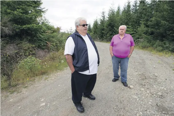  ??  ?? Tlowitsis First Nation Coun. Thomas Smith, left, and his brother, John, who is chief, stand on property the Tlowitsis have agreed to purchase: 630 acres of private forest land south of Campbell River. The plan calls for the Tlowitsis to pay $3.5...