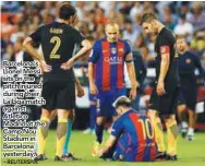  ?? – REUTERSPIX ?? Barcelona’s Lionel Messi sits on the pitch injured during their La Liga match against Atletico Madrid at the Camp Nou Stadium in Barcelona yesterday.