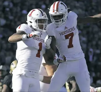  ?? Michael Conroy/Associated Press ?? Taysir Mack, right, celebrates a catch with then-Indiana teammate Simmie Cobbs Jr. against Purdue. He caught 23 passes for 310 yards and three touchdowns on the season.