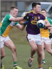  ??  ?? Wexford attacker Eoghan Nolan ships a tackle during Saturday’s Allianz Football League Division 3 defeat to Offaly in St. Patrick’s Park, Enniscorth­y.