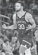  ?? JEFF CHIU/AP ?? Warriors guard Stephen Curry reacts after making a 3-pointer against the Thunder on Nov. 18.