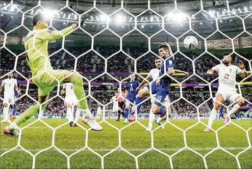  ?? Manu Fernandez / Associated Press ?? Christian Pulisic of the the United States scores his side’s loan goal during the World Cup group B soccer match against Iran at the Al Thumama Stadium in Doha, Qatar on Tuesday. The U.S. won 1-0.