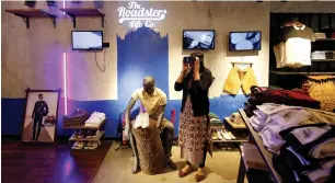  ?? — Reuters ?? A customer uses a virtual reality headset to browse through products inside a Roadster store in Bengaluru. Millions of Indian shoppers use low-cost alternativ­es by private label brands.