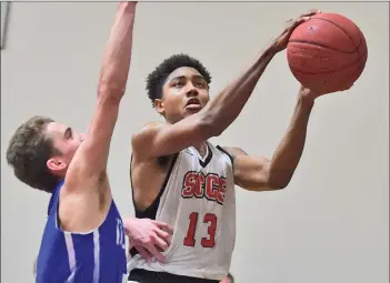  ?? Dan Watson/The Signal ?? (Above) Santa Clarita Christian’s Justin Collins (13) shoots against Morro Bay defender Kalvin Hilliard (5) at a basketball game at SCCS on Friday. (Below) Santa Clarita Christian’s Josh Fehr (34) shoots against Morro Bay defender Boden Reaber (34) at...