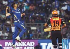  ?? AFP ?? Mumbai Indians pacer Jasprit Bumrah (left) celebrates after dismissing Hyderabad’s Rashid Khan.