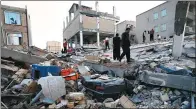  ?? POURIA PAKIZEH / AGENCE FRANCE-PRESSE ?? In Sarpol-e-Zahab, Iran, where the most damage was reported, rescuers work on Monday amid the rubble to find survivors.