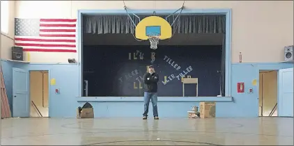  ?? AP PHOTO ?? In this April 5, 2017, photo, Garrett Zoller, principal broker with Landandwil­dlife.com, stands under a basketball hoop in the abandoned gym of Tiller Elementary School in Tiller, Ore. A potential buyer has come forward but is remaining anonymous — and...