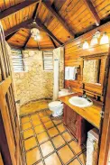  ?? ?? A unique cutstone and wood finished bathroom.