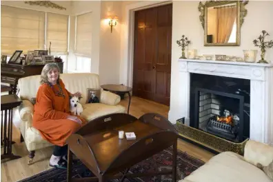  ??  ?? LEFT: Maria Ines Dawnay in her drawing room with some furniture from her previous home. The grand piano belonged to Hugh. The top of the piano is covered with photos from his polo-playing days