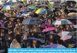  ??  ?? NEWTOWN, CT: Mourners attend a community vigil at Newtown High School for the victims of last week’s mass shooting at Marjory Stoneman Douglas High School in Parkland, Florida, on Friday. — AFP