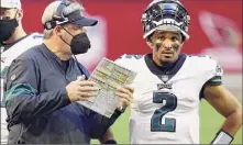  ?? Christian Petersen / Getty Images ?? Head coach Doug Pederson is facing criticism from his own players after pulling starting quarterbac­k Jalen Hurts (2) in a close game against the Washington Football Team in favor of Nate Sudfeld. The Eagles lost 20-14.