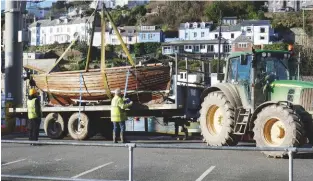  ??  ?? Peter Pan is lowered by crane onto a trailer at Looe ready for her road trip to a barn