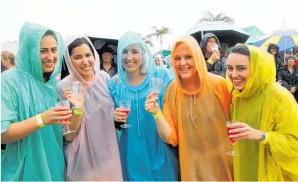  ?? Photo / Peter de Graaf ?? Even rain couldn’t dampen the spirit of these revellers at a previous It! Bay of Islands Food and Wine Festival.