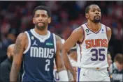  ?? GARETH PATTERSON — THE ASSOCIATED PRESS ?? Dallas Mavericks guard Kyrie Irving (2) and Phoenix Suns forward Kevin Durant (35) walk down the court during the second half on Sunday in Dallas.
