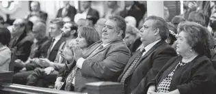  ?? Billy Calzada / Staff photograph­er ?? The family of Commission­er Paul Elizondo, who died last month, attends the first Commission­ers Court meeting of the year. Elizondo’s widow, Irene, right, was honored with the Hidalgo Award.