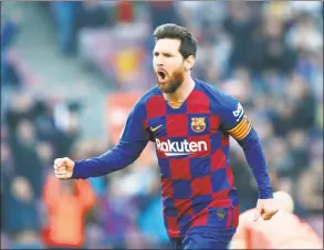  ?? Joan Monfort / Associated Press ?? Barcelona’s Lionel Messi celebrates after scoring his side’s opening goal during a Spanish La Liga match against Eibar in February.