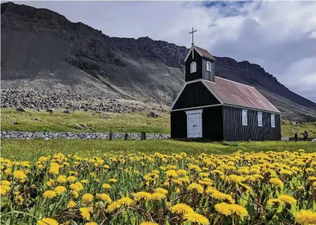  ?? Photos by Jen Rose Smith / For the Washington Post ?? Painted a striking black, Saurbaer Church overlooks the red-sand Raudasandu­r beach.