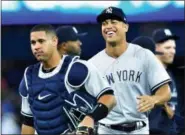  ?? FRANK GUNN — THE CANADIAN PRESS VIA AP ?? Yankees Giancarlo Stanton, right, and catcher Gary Sanchez, left, celebrate with teammates after defeating the Blue Jays on Thursday.