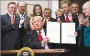  ?? PHOTO BY JABIN BOTSFORD — THE WASHINGTON POST ?? President Trump signs an executive order on health care Thursday at the White House.