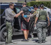  ?? Bobby Block/The Signal ?? (Above and below) SCV Sheriff’s Station deputies detain a man suspected of robbery near the 276000 block of Bouquet Canyon Road on Tuesday.