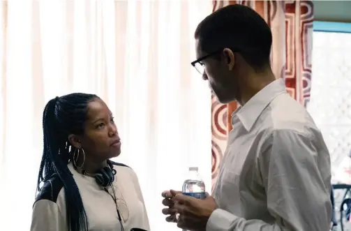  ??  ?? Director Regina King talks with actor Kingsley Ben-adir on the set of “One Night in Miami.”