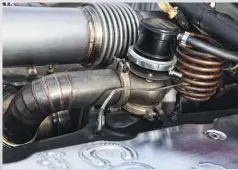  ??  ?? The Ram’s exhaust system is a work of art, with an integrated 45mm Turbosmart wastegate, accordion-style expansion tubes, and a copper drive pressure line to measure exhaust backpressu­re.