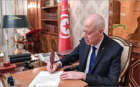  ?? TUNISIAN PRESIDENCY/AFP ?? Tunisian president Kais Saied (pictured) perfected his calligraph­y by training with well-known calligraph­er Omar Jomni.