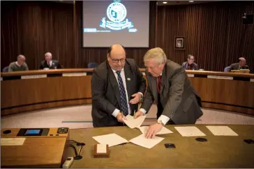  ?? Herald photo by Tijana Martin ?? Lethbridge County Reeve Lorne Hickey, left, and Lethbridge Mayor Chris Spearman, co-sign documents following the announceme­nt that the City of Lethbridge will be taking over Lethbridge Airport. @TMartinHer­ald