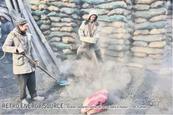  ??  ?? Afghan labourers works at a coal yard in Kabul. — AFP photo