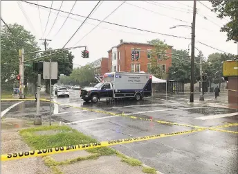  ?? Ben Lambert / Hearst Connecticu­t Media ?? Police are out in strength in the areas around Dixwell Avenue and Henry Street in New Haven as they search for the man who shot Capt. Anthony Duff multiple times Monday night.