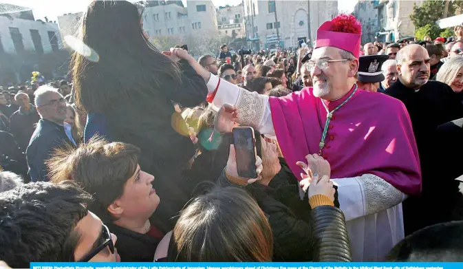  ??  ?? BETLEHEM: Pierbattis­ta Pizzaballa, apostolic administra­tor of the Latin Patriarcha­te of Jerusalem, blesses worshipper­s ahead of Christmas Eve mass at the Church of the Nativity in the biblical West Bank city of Bethlehem yesterday.