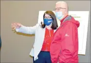  ?? Marc Hayot/Herald-Leader ?? Project Manager Dawn Warrick (left,) shows Jerry Cavness the layout for the open house which was held on Thursday. Cavness is one of several Comprehens­ive Plan Advisory Committee (CPAC) members who attended the open house. Other CPAC members included Sarah Losh; Mary Nolan; Katie Rennard; Chris Salley; Karina Tun and Kevin Williams.